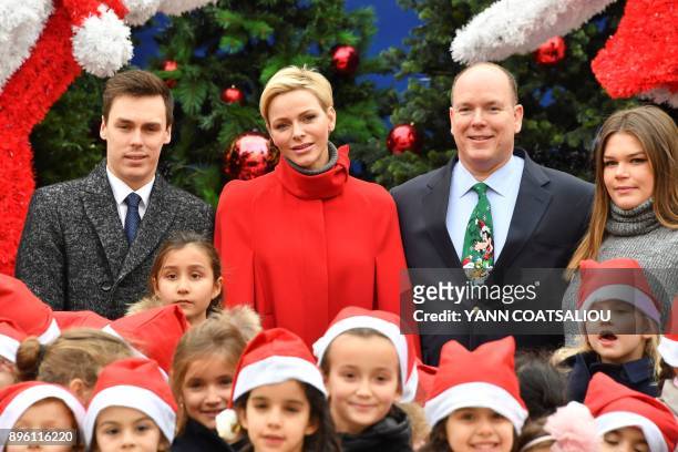 Princess Charlene of Monaco , Prince Albert II of Monaco , his nephew Daniel Ducruet and niece Camille Gotlieb pose during the Children's Christmas...