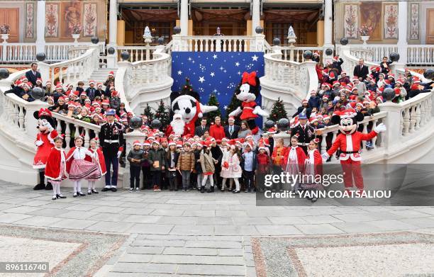 Princess Charlene of Monaco , Prince Albert II of Monaco , his nephew Daniel Ducruet and niece Camille Gotlieb pose during the Children's Christmas...