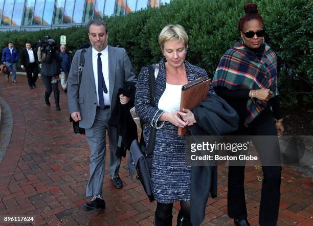 Attorneys Michael Tumposky, left, and Jessica Hedges center, leave the Moakley Federal Courthouse in Boston after the sentencing of David Wright on...