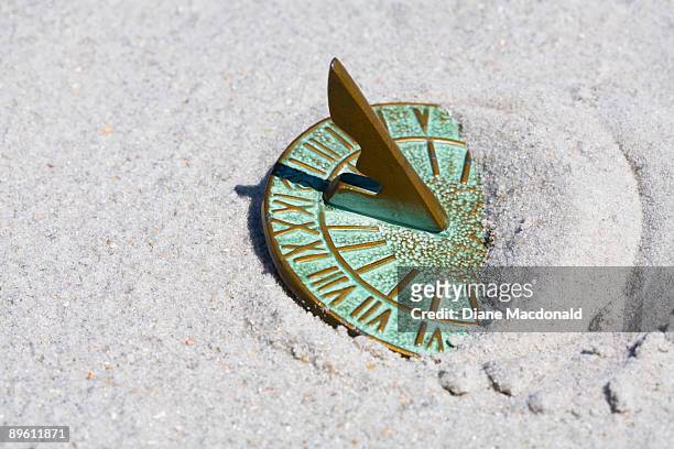 a sundial in the sand at noon - sandy macdonald stock pictures, royalty-free photos & images