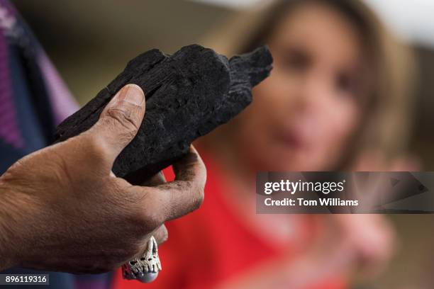 Rep. Sheila Jackson Lee, D-Texas, holds a piece of coal during a news conference in the Capitol on December 20 to symbolize the Christmas present to...