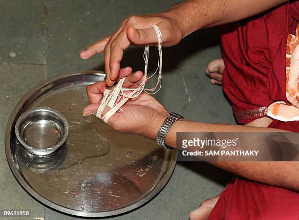Indian Gugli Brahmins, originally from Dwarka near New Delhi, participate in a 'Sacred Thread Changing Ceremony' on the occasion of Raksha Bandhan at...