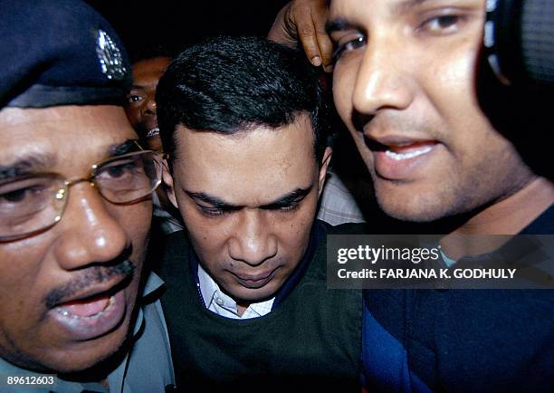 File picture taken on March 12, 2007 showing Bangladeshi policemen escorting Tareque Rahman , joint senior general secretary of the Bangladesh...