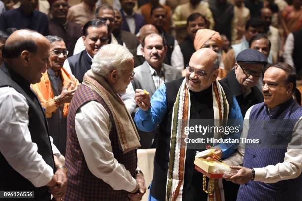 Prime Minister Narendra Modi being felicitated by BJP President Amit Shah after success in Gujarat and Himachal Pradesh Assembly elections during the...