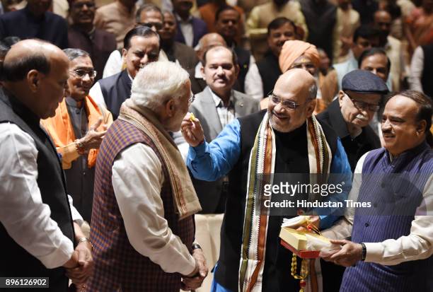 Prime Minister Narendra Modi being felicitated by BJP President Amit Shah after success in Gujarat and Himachal Pradesh Assembly elections during the...