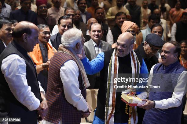 Prime Minister Narendra Modi being felicitated by BJP President Amit Shah after success in Gujarat and Himachal Pradesh Assembly elections during the...