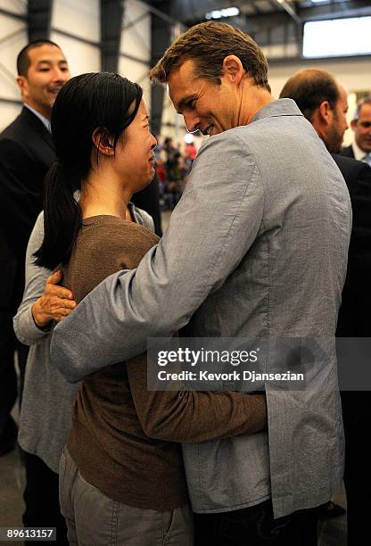 Journalists Laura Ling hugs husband Iain Clayton as Ling arrives with Euna Lee at Hangar 25 on August 5, 2009 in Burbank, California after being...