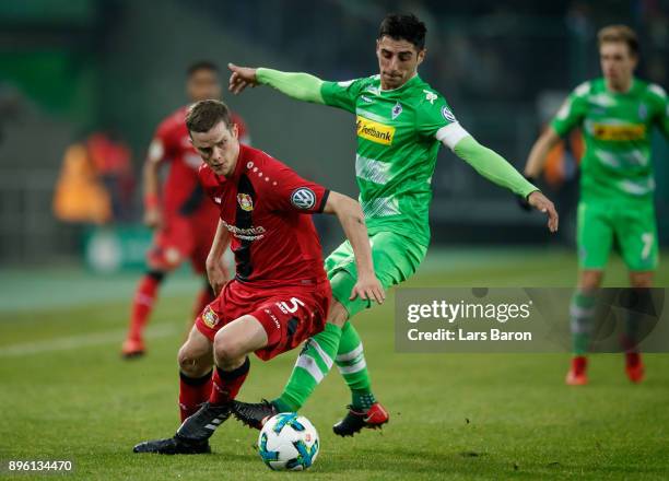 Sven Bender of Leverkusen is challenged by Lars Stindl of Moenchengladbach during the DFB Cup match between Borussia Moenchengladbach and Bayer...