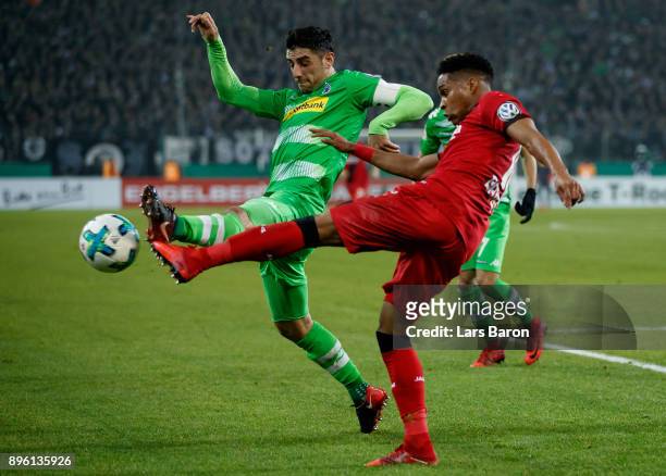 Lars Stindl of Moenchengladbach challenges Wendell of Bayer Leverkusen during the DFB Cup match between Borussia Moenchengladbach and Bayer...