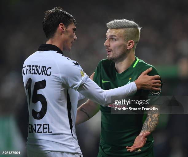 Jerome Gondorf of Bremen discusses a challenged by Pascal Stenzel of Freiburg during the DFB Cup match between Werder Bremen and SC Freiburg at...