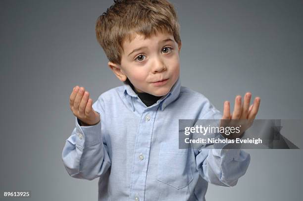 portrait of young boy in blue shirt - explain stock-fotos und bilder
