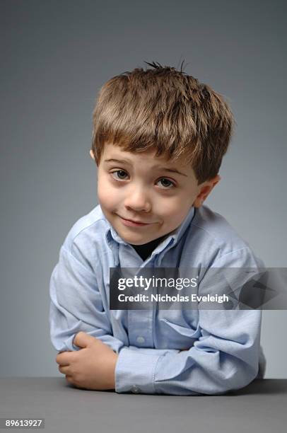 portrait of young boy in blue shirt - irony stock pictures, royalty-free photos & images