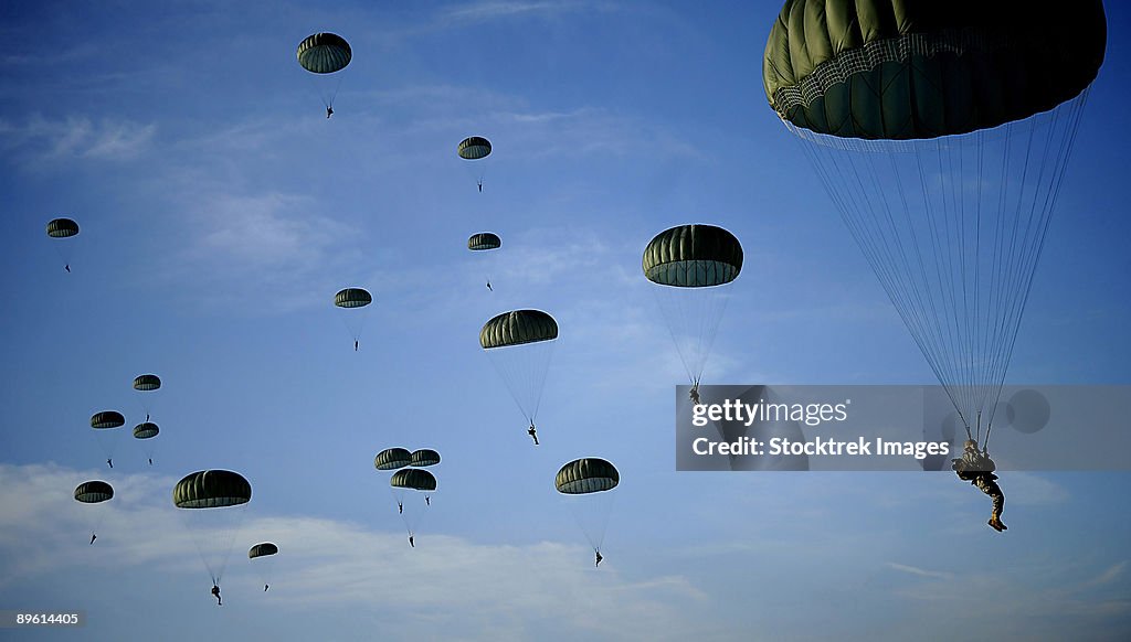 December 6, 2008 - U.S. Army Soldiers descend under a parachute canopy to earn foreign jump wings during Operation Toy Drop at Ft. Bragg, North Carolina.