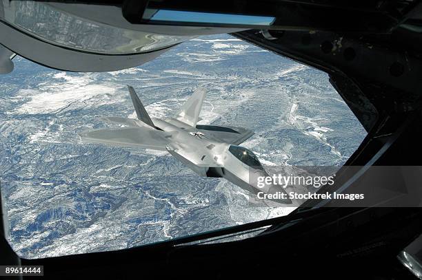 an f-22 raptor banks away from a kc-135 statotanker during a refueling operation. - f 22 raptor stock pictures, royalty-free photos & images