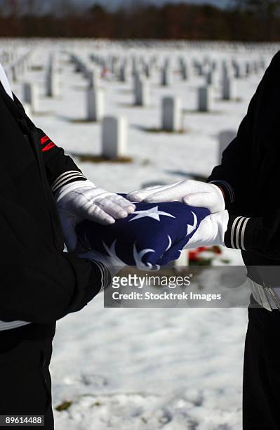 february 22, 2005 - marines perform flag folding honors for a funeral service held at the calverton national cemetery in long island, new york.  - calverton national cemetery stock pictures, royalty-free photos & images