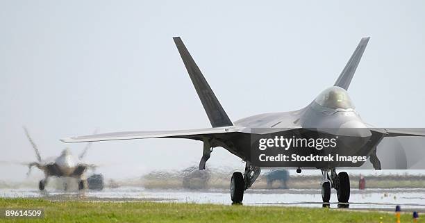 langley air force base, virginia - two f-22a raptors taxi down the runway.  - langley air force base stock pictures, royalty-free photos & images