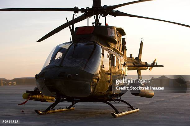 an oh-58d kiowa during sunset. - camp speicher stock pictures, royalty-free photos & images