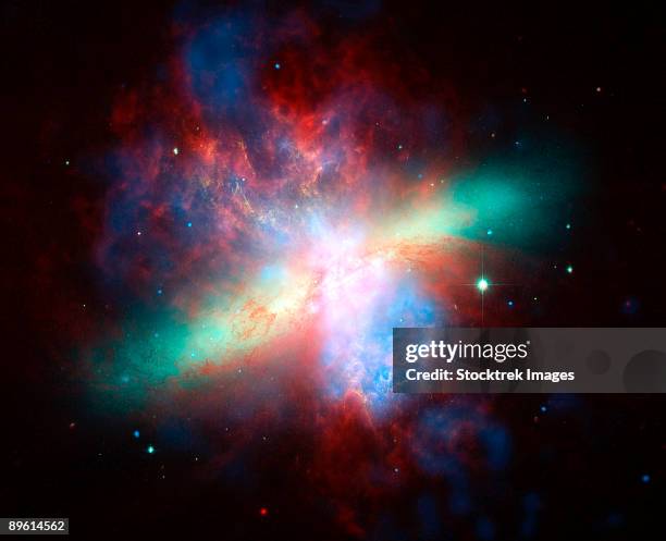 false-colored view of the messier 82 (m82) galaxy. - starburst galaxy stock pictures, royalty-free photos & images