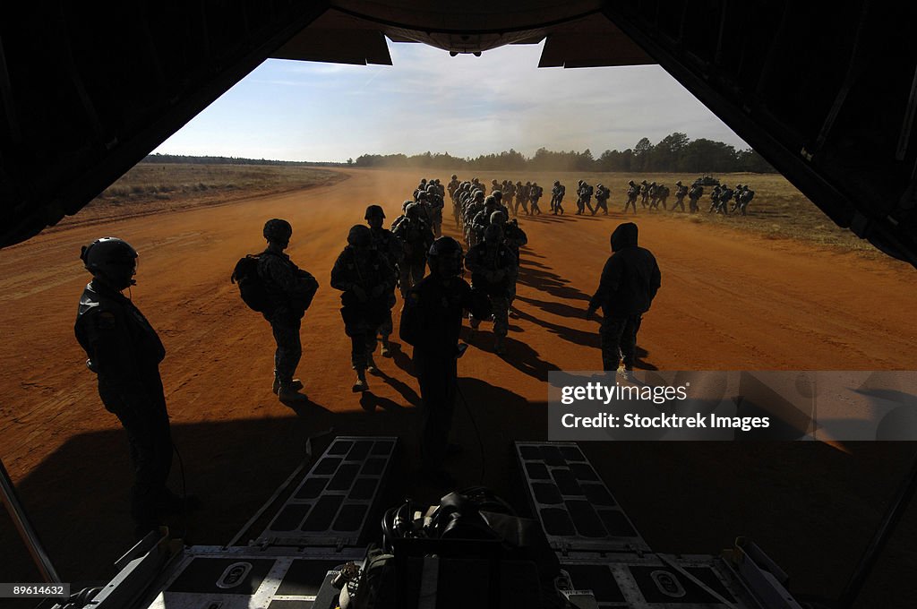 Soldiers board a C-130 Hercules during Operation Toy Drop.