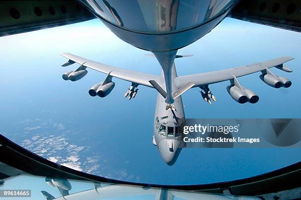 a kc-135 stratotanker refuels a b-52 stratofortress over the indian ocean.  - sprengkörper stock-fotos und bilder