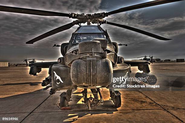 tikrit, iraq - a 7 exposure  hdr image of an ah-64d apache helicopter as it sits on its pad. - camp speicher stock pictures, royalty-free photos & images