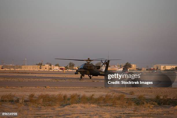 tikrit, iraq - an ah-64 apache waits for clearance from the flight tower on camp speicher. - camp speicher stock pictures, royalty-free photos & images