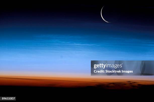 this image shows the limb of the earth at the bottom transitioning into the orange-colored troposphere, the lowest and most dense portion of the earth's atmosphere. - troposphere stock pictures, royalty-free photos & images