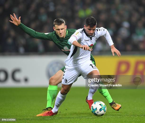 Maximilian Eggestein of Bremen is challenged by Marco Terrazzino of Freiburg during the DFB Cup match between Werder Bremen and SC Freiburg at...