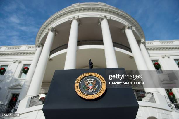 The Presidential Seal is seen on the podium prior to US President Donald Trump speaking about the passage of tax reform legislation on the South Lawn...