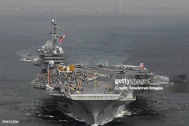 yokosuka, japan, september 17, 2006 - japanese guests and family members gather on the flight deck of uss kitty hawk (cv-63) to watch sailors prepare for a flight demonstration during a family day cruise.   - kitty hawk stock-fotos und bilder