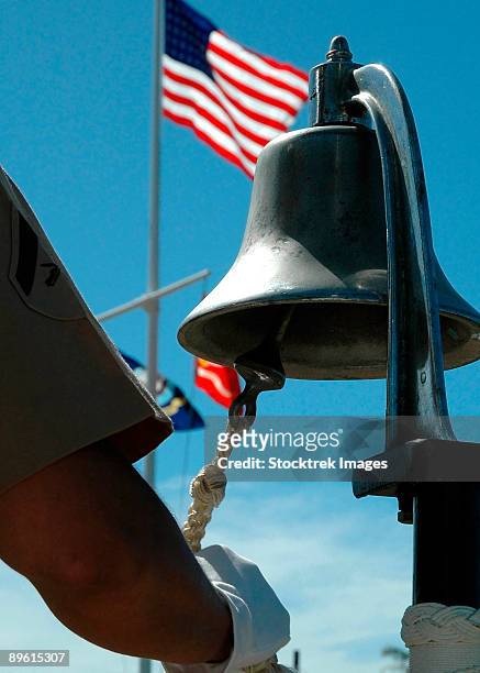 u.s. marine sounds a bell honoring fallen marines. - uss_arizona stock pictures, royalty-free photos & images