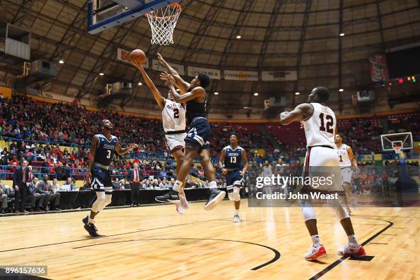 Zhaire Smith of the Texas Tech Red Raiders goes to the basket for a lay up against Najja Hunter of the Rice Owls during the game against the Rice...