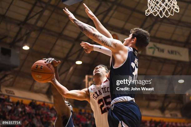 Davide Moretti of the Texas Tech Red Raiders is fouled by Austin Meyer of the Rice Owls during the game on December 16, 2017 at Lubbock Municipal...