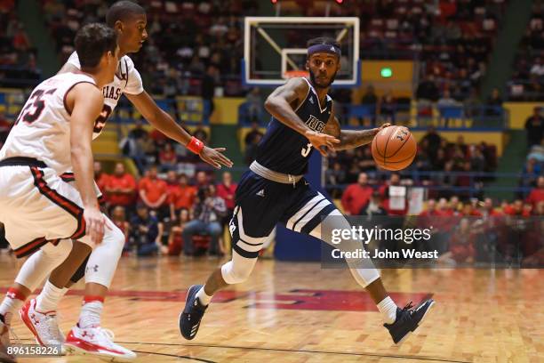 Ako Adams of the Rice Owls handles the ball during the game against the Texas Tech Red Raiders on December 16, 2017 at Lubbock Municipal Coliseum in...