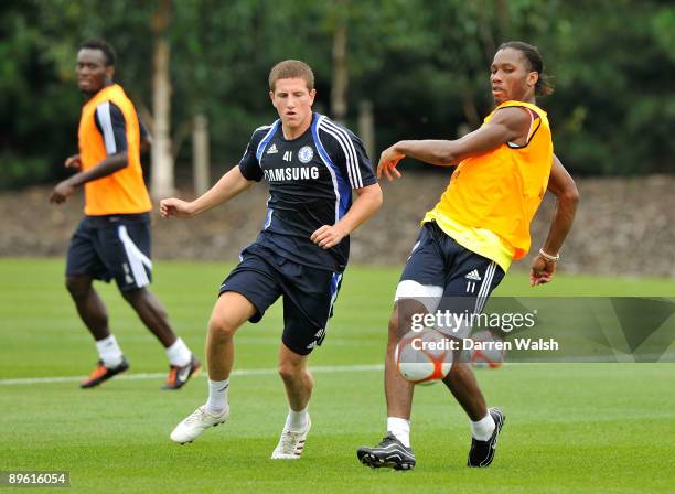 Didier Drogba and Sam Hutchinson of Chelsea during training at the Cobham Training ground on August 5, 2009 in Cobham, Surrey.