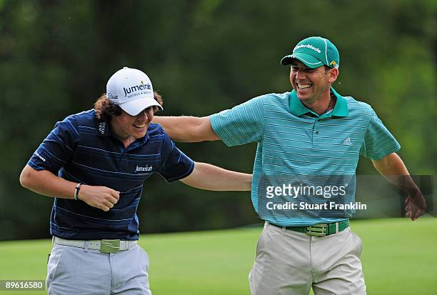 Rory McIlroy of Northern Ireland and Sergio Garcia of Spain enjoy themselves during a practice round of the World Golf Championship Bridgestone...