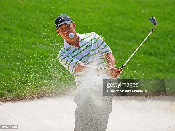 Anthony Kim of USA plays his bunker shot during a practice round of the World Golf Championship Bridgestone Invitational on August 5, 2009 at...