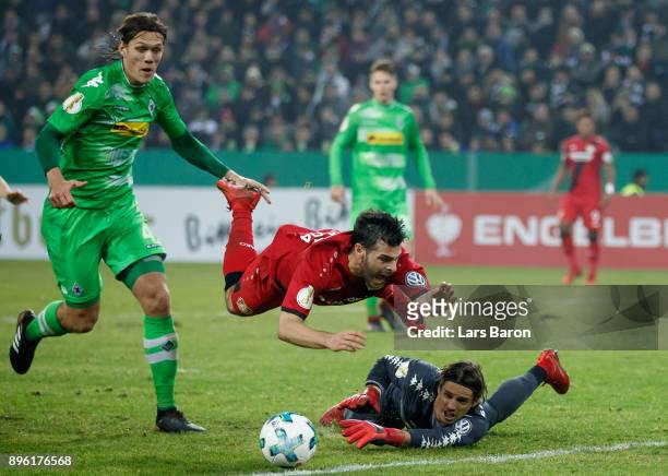 Kevin Volland of Bayer Leverkusen is challenged by Jannik Vestergaard of Moenchengladbach and Yann Sommer of Moenchengladbach during the DFB Cup...