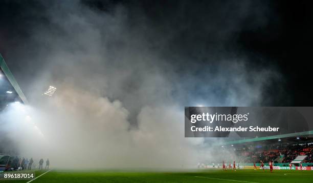 Fans of Eintracht Frankfurt burn flares / firework during the DFB Cup match between 1. FC Heidenheim and Eintracht Frankfurt at Voith-Arena on...