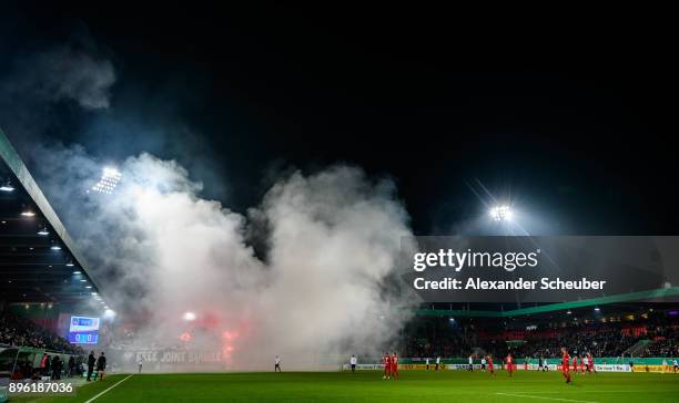 Fans of Eintracht Frankfurt burn flares / firework during the DFB Cup match between 1. FC Heidenheim and Eintracht Frankfurt at Voith-Arena on...