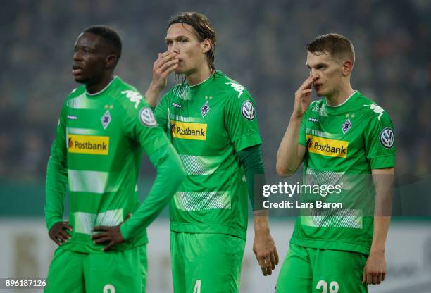 Denis Zakaria of Moenchegladbach, Jannik Vestergaard of Moenchengladbach and Matthias Ginter of Moenchengladbach are looking dejected during the DFB...