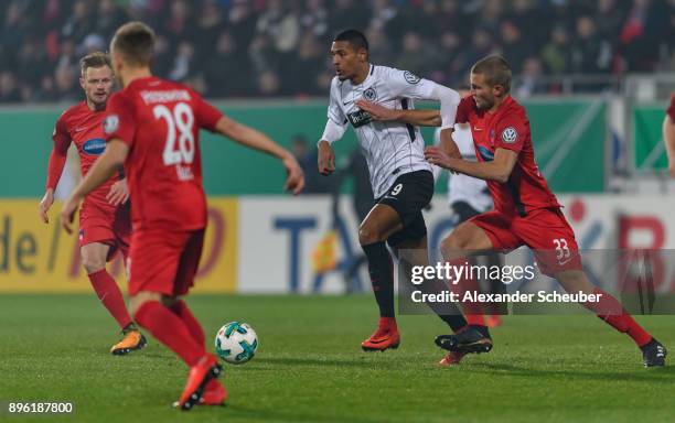 Timo Beermann of Heidenheim challenges Sebastian Haller of Eintracht Frankfurt during the DFB Cup match between 1. FC Heidenheim and Eintracht...