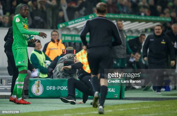 Head coach Heiko Herrlich of Leverkusen falls down next to Denis Zakaria of Moenchegladbach during the DFB Cup match between Borussia...