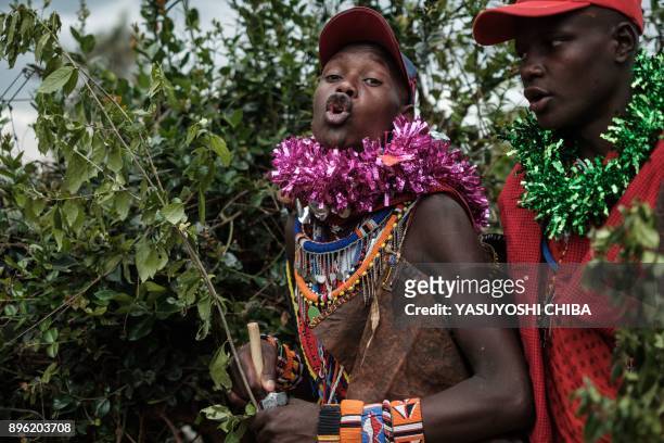Circumcised Maasai young men react after coming out from the bush near Kilgoris, Kenya, on the last day of the annual one-month-long circumcision...