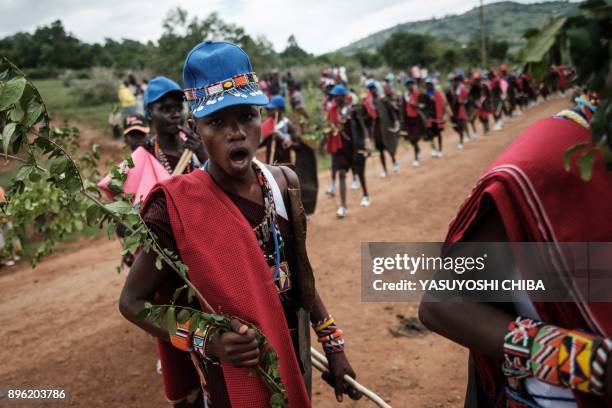 Circumcised Maasai young men wearing new cloths and accessories come out from the bush near Kilgoris, Kenya, on the last day of the annual...