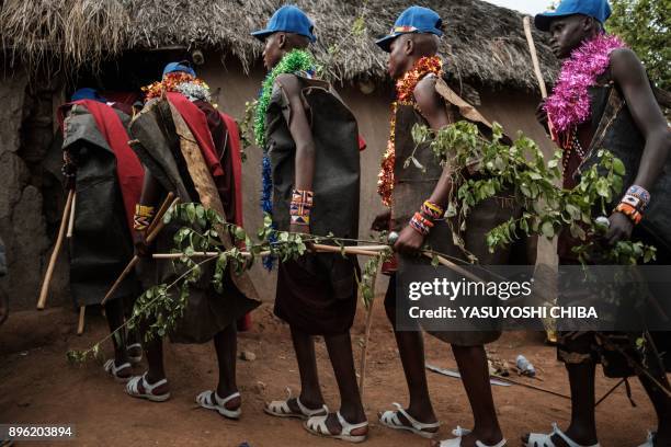 Circumcised Maasai young men enter a house to receive the final lecture on the last day of the annual one-month-long circumcision ceremony, on...