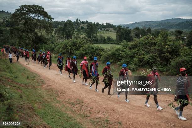 Circumcised Maasai young men wearing new cloths and accessories come out from the bush near Kilgoris, Kenya, on the last day of the annual...