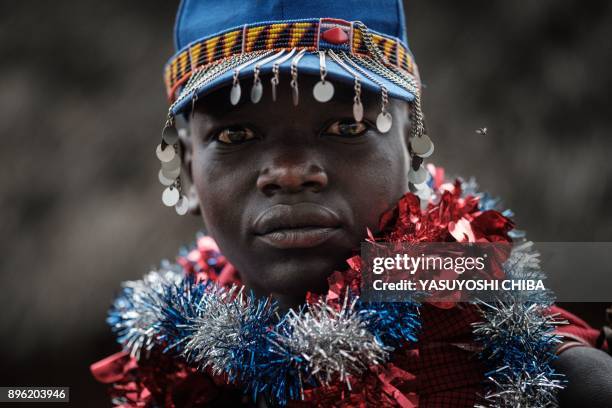 Circumcised Maasai young man poses after coming out from the bush near Kilgoris, Kenya, on the last day of the annual one-month-long circumcision...