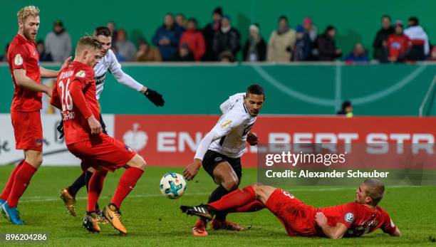 Timo Beermann of Heidenheim challenges Sebastian Haller of Eintracht Frankfurt during the DFB Cup match between 1. FC Heidenheim and Eintracht...