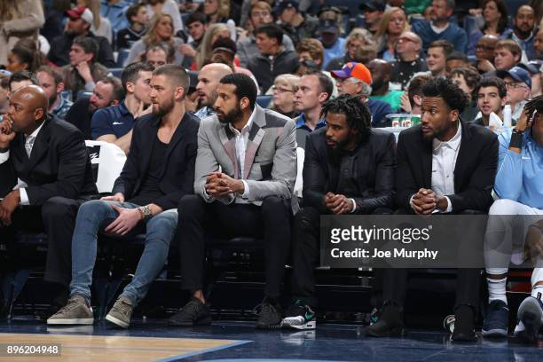 Chandler Parsons, Brandan Wright, Mike Conley and Wayne Selden of the Memphis Grizzlies look on from the bench during the game against the Boston...
